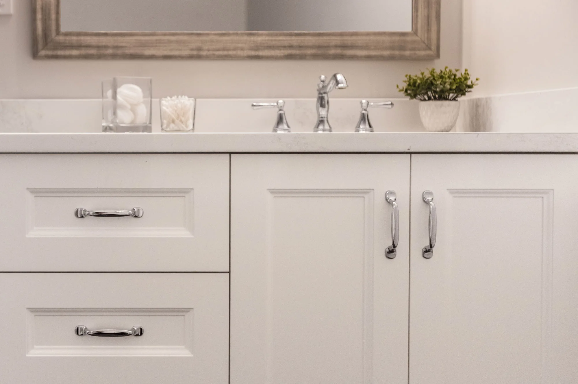 Close up of a white with silver hardware bathroom vanity
