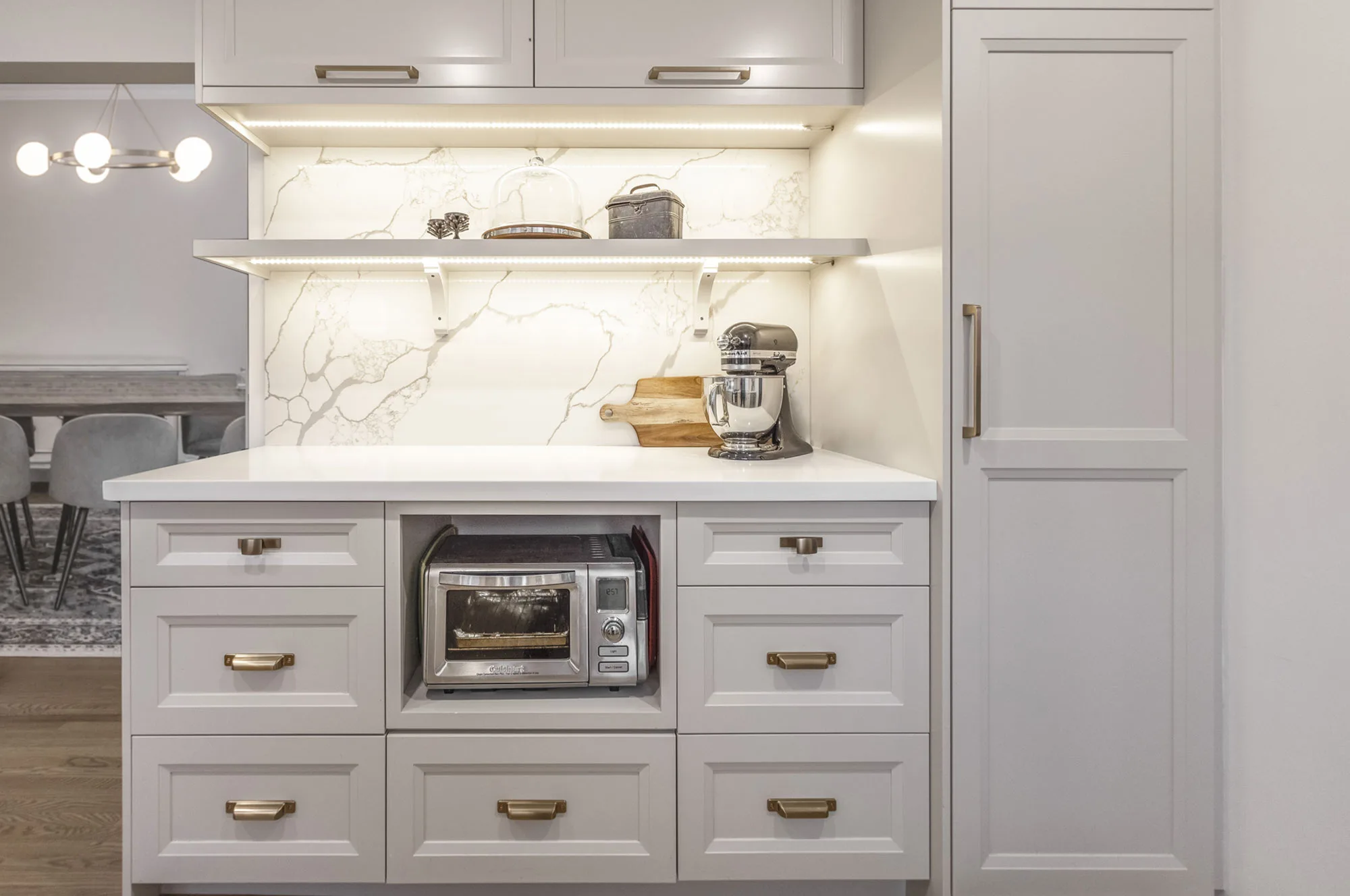 Beautiful off-white kitchen with gold handles with stainless steel applicance